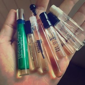 Lot of 9 designer perfumes and a black velvet bag